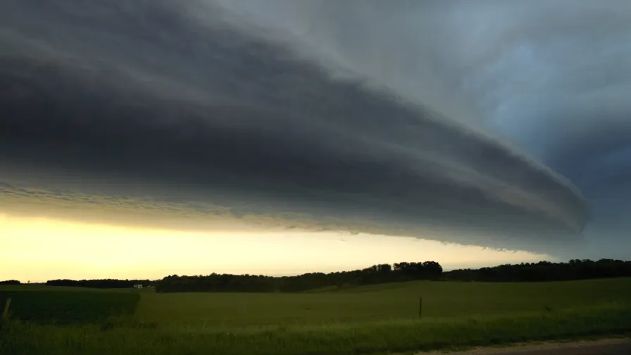Shelf cloud with a hard leading edge advancing over green Missouri farmland